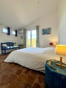 a bedroom with a large bed and a window at Villa Gardelina in Campomoro