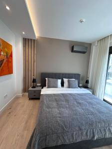 a bedroom with a large bed and a large window at Alimos Escape in Mesochórion +24 photos