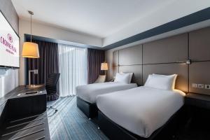 a hotel room with two beds and a television at Crowne Plaza Aberdeen Airport by IHG in Dyce +37 photos