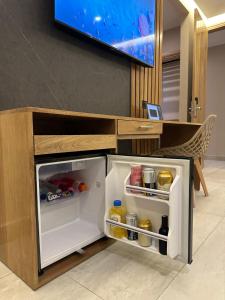 a refrigerator with its door open in a kitchen at Hotel y Cabañas Covemar in Coveñas