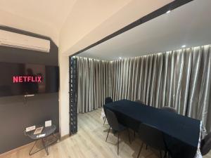 a meeting room with a blue table and chairs at Stylish loft with view and terrace Maarif Gauthier in Casablanca