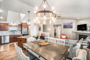 a kitchen and living room with a wooden table in a room at Ranch Retreat W Hot Tub & Patio in Cheyenne