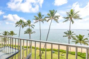a view of the beach from the balcony of a resort at Amazing 7th floor Beachfront Condo in Hauula