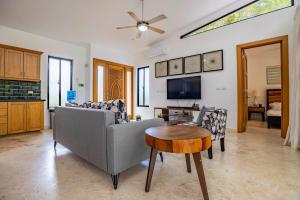 a living room with a couch and a table at Casa Linda Villa 767 - Sosua in Sosúa