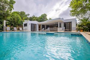 a large swimming pool in front of a house at Casa Linda Villa 767 - Sosua in Sosúa