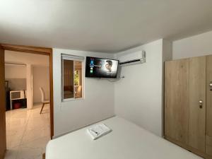 a room with a flat screen tv on the wall at Air-conditioned apartment 201 in Floridablanca +2 photos