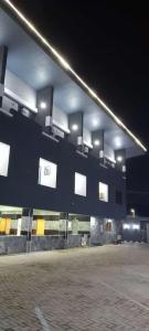 a building with lights on the side of it at La VOD Hotel in Benin City