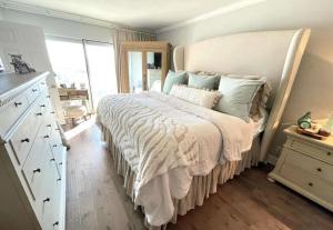 a bedroom with a large bed with a large window at Regency Towers Unit 803E in Pensacola Beach