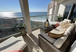 a balcony with a couch and a view of the ocean at Regency Towers Unit 803E in Pensacola Beach