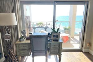 a room with a large sliding glass door with a view of the ocean at Regency Towers Unit 803E in Pensacola Beach