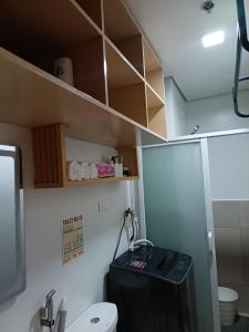 a small bathroom with a toilet and a sink at Cheers SMDC Condominium in Marilao