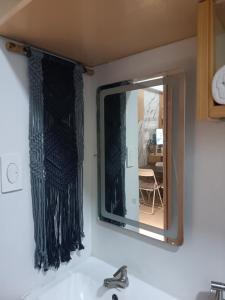 a mirror above a sink in a bathroom at Amanda and Cossette Staycation in Marilao +22 photos