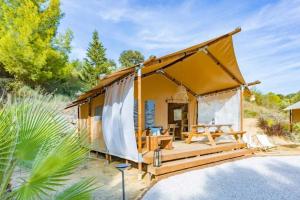 a tiny house in the desert with a porch at Camping 3 étoiles - Piscine - cca0gbb in Apremont