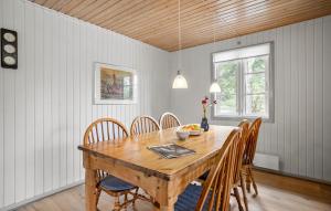 a dining room with a wooden table and chairs at Cozy Home In Aakirkeby With Wifi in Vester Sømarken