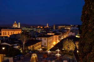 a view of a city at night at Hotel Kraft in Florence