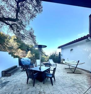 a patio with a table and chairs on a patio at Your Vacation Home in the Hills of Studio City in Studio City