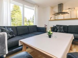 a living room with a couch and a table at 14 person holiday home in Væggerløse-By Traum in Marielyst