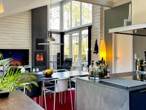 a kitchen with a table and chairs in a room at Luxury Spa Retreat in Thorsager - By Traum Ferienwohnungen in Rønde