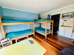 a room with two bunk beds and a table at Apart Newen Osorno in Osorno