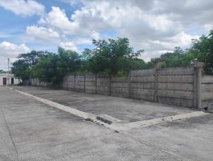 a wooden fence in front of a parking lot at Valor Ain Villa in Tarlac