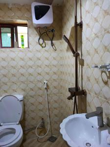 a bathroom with a toilet and a sink at Bright Michelle Homestay in Lushoto +36 photos