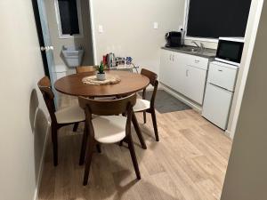 a dining room table and chairs in a kitchen at Sunflower Cottage in Dargaville