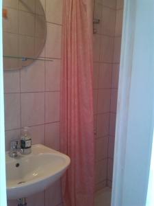 a bathroom with a sink and a shower at Rooms with WiFi Korcula - 24232 in Korčula +4 photos