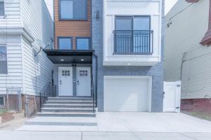 a front door of a house with a white garage at muiz villa in Newark