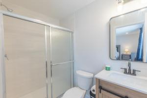 a bathroom with a shower and a toilet and a sink at muiz villa in Newark +3 photos