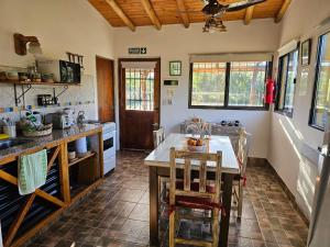 a kitchen with a table and chairs in a room at Arawi Cabaña in Merlo