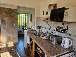 a kitchen with a counter with a sink and a microwave at Arawi Cabaña in Merlo
