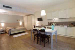 a kitchen and living room with a table and chairs at Agriturismo Ai Prati in Lazise