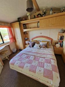 a bedroom with a large bed in a room at Sea View Escape 2 Bedroom Pet Friendly Caravan at Clarach Bay Gm3 in Aberystwyth