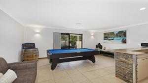 a living room with a pool table in it at Sunset On View - Picturesque Coastal Setting With Pool in The Entrance
