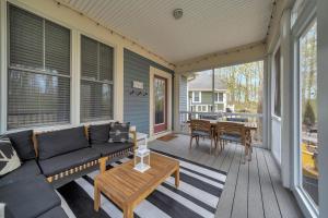 a screened in porch with a couch and a table at The Elm - 36 Hollow in Cherry Valley