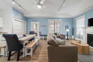 a living room with blue walls and a dining room at The Elm - 36 Hollow in Cherry Valley