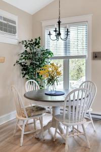 a dining room with a table and chairs and a window at Le Wapiti - 75 Butternut in Cherry Valley +89 photos