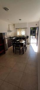 a kitchen and dining room with a table and chairs at Las Costas - Tu descanso in Cañuelas +8 photos