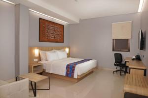 Ein Bett oder Betten in einem Zimmer der Unterkunft Best Western Sagita Hotel Jayapura