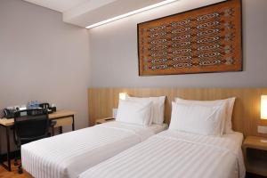 Ein Bett oder Betten in einem Zimmer der Unterkunft Best Western Sagita Hotel Jayapura