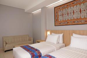 Ein Bett oder Betten in einem Zimmer der Unterkunft Best Western Sagita Hotel Jayapura