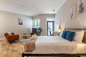 a bedroom with a large bed with blue pillows at CozySuites - Penrose On Mass with pool and parking#10 in Indianapolis