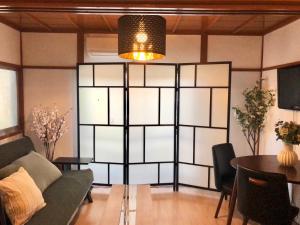 a living room with a couch and a table at HOKUSAI-KAN Osaka Taisho in Osaka