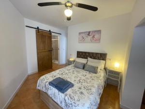 a bedroom with a bed and a ceiling fan at Piso Luna in Mojácar