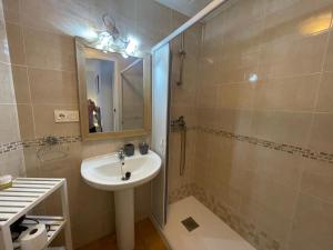 a bathroom with a sink and a shower with a mirror at Piso Luna in Mojácar +18 photos