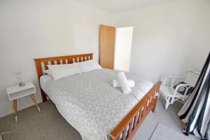a bedroom with a bed with a teddy bear on it at Mackenzie Batch in Twizel