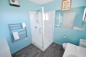 a bathroom with a shower and a toilet at Mackenzie Batch in Twizel