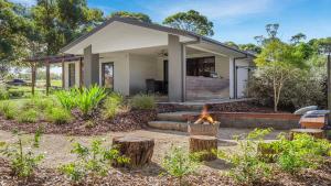 a small house with a fire in a yard at The Modern Vintage in Pokolbin