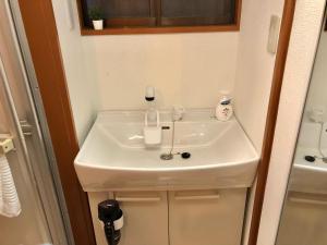 a bathroom sink with two bottles on top of it at HOKUSAI-KAN Osaka Taisho in Osaka +21 photos