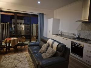 a living room with a couch and a kitchen at Pemberton Japanese Garden Studio 2025 Winner Travellers Award in Pemberton